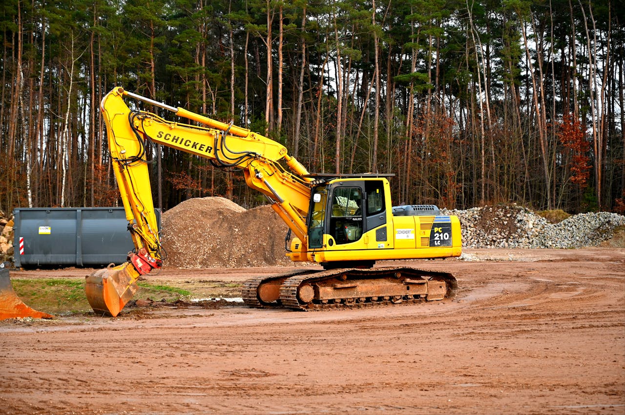 Yellow and Black Excavator on Brown Soil